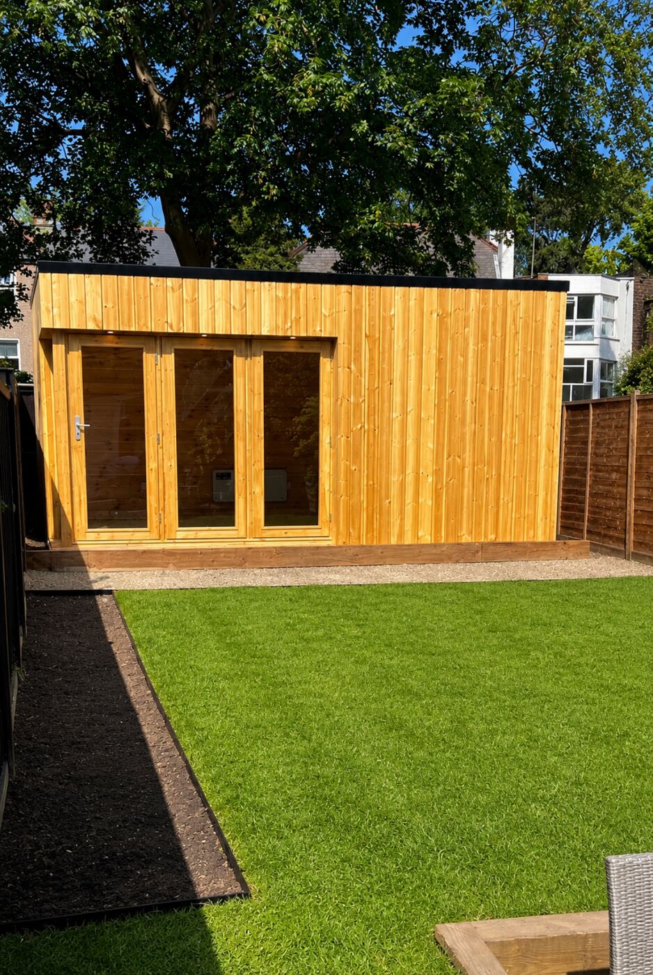 Natural timber garden room at the end of a lawn