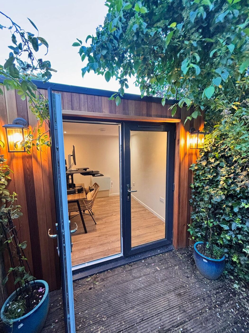 Cedar garden office with doors open onto a timber deck